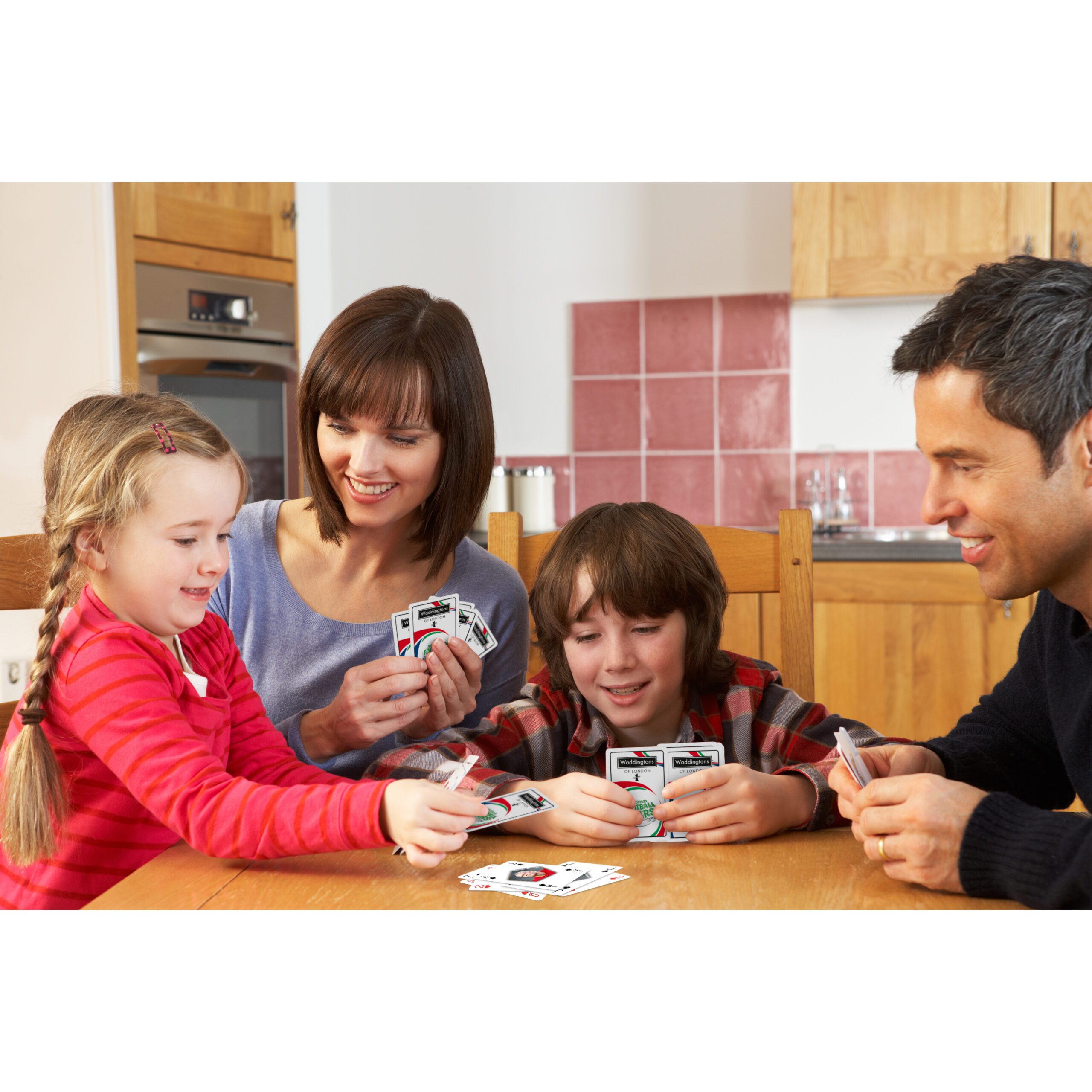 Family,Playing,Cards,In,Kitchen